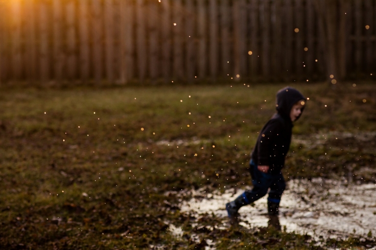 Toledo Child Photographer boy in puddle outside photo by Cynthia Dawson Photography