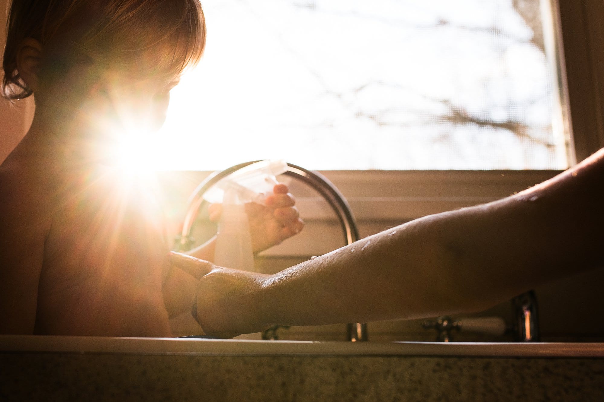 Lifestyle Photographer Toledo Ohio close up of siblings in the kitchen sink photo by cynthia dawson photography