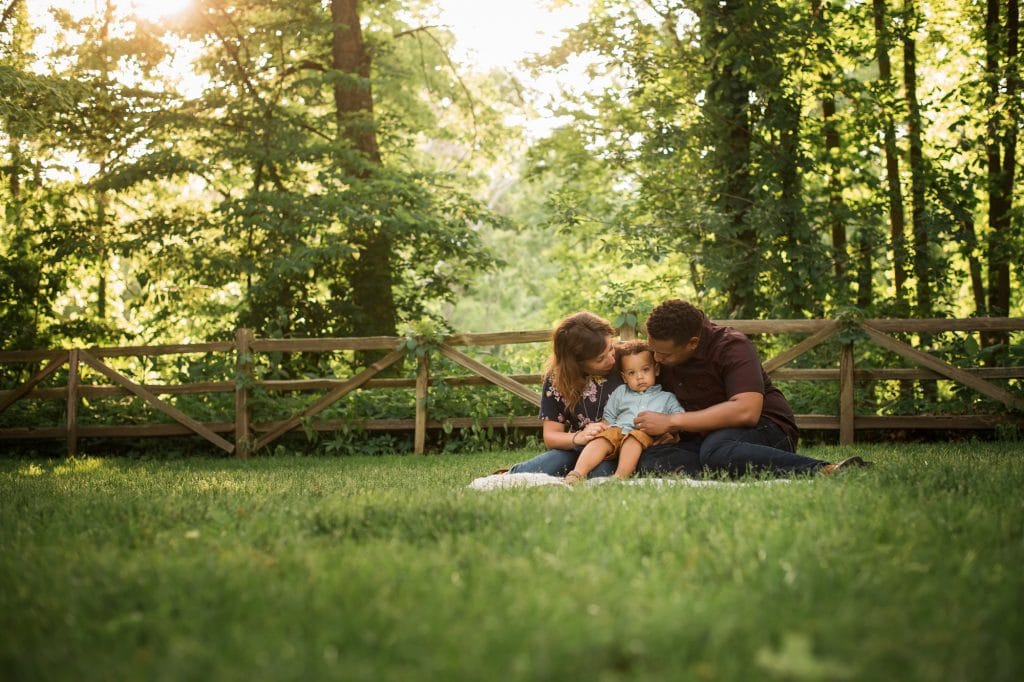 Family Photographer Perrysburg Ohio parents looking at son photo by Cynthia Dawson Photography