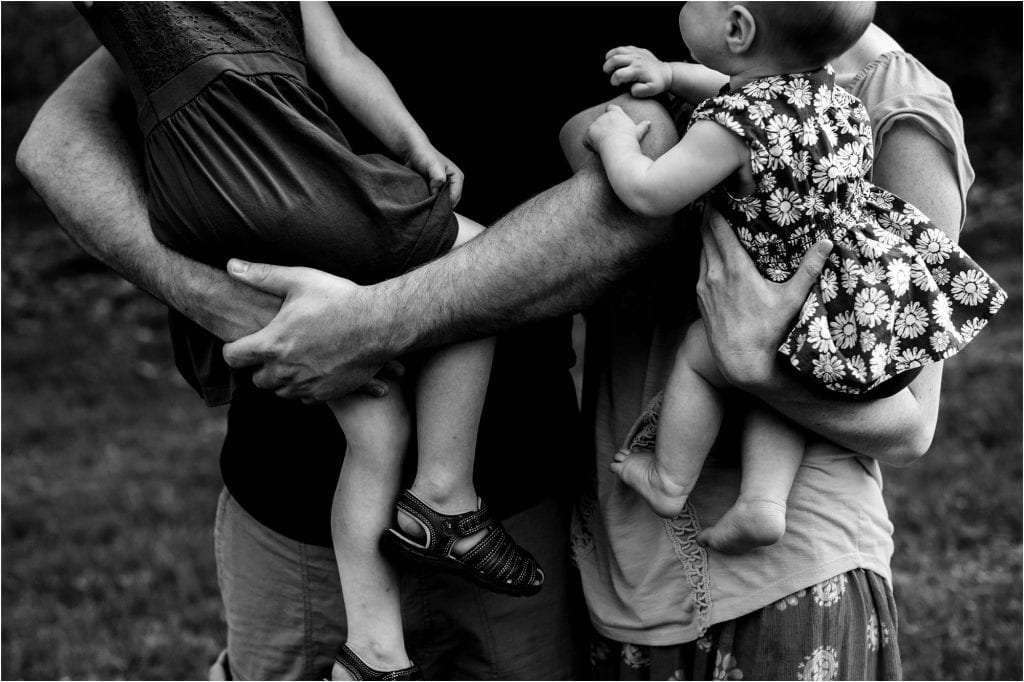 Northwest Ohio Family Lifestyle Photographer close up of kids in parents arms photo by Cynthia Dawson Photography