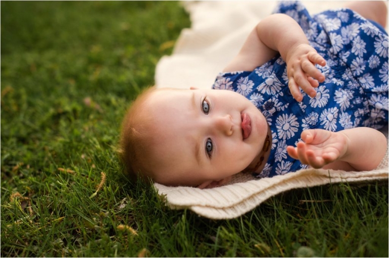 Northwest Ohio Family Lifestyle Photographer baby girl laying on grass photo by Cynthia Dawson Photography