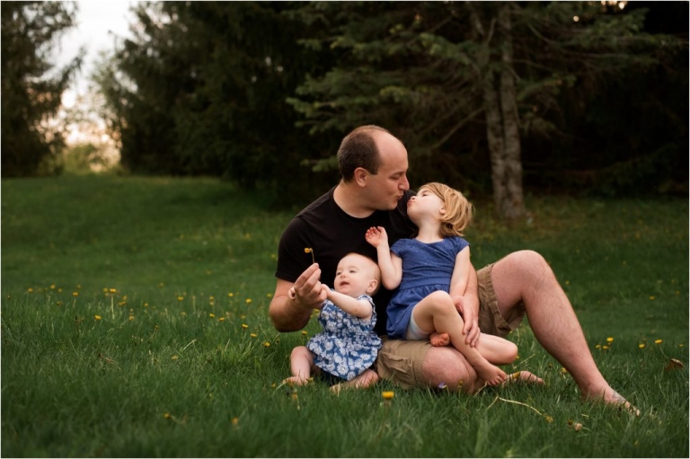 Northwest Ohio Family Lifestyle Photographer father kissing two daughters photo by Cynthia Dawson Photography