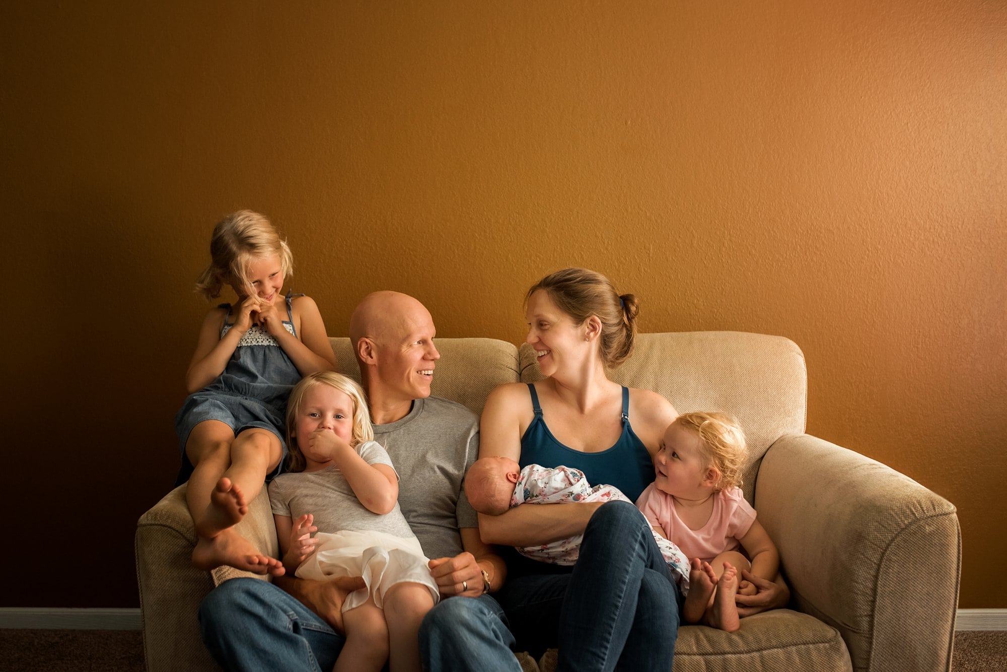 Newborn Photos in Toledo Ohio family on couch with newborn photo by Cynthia Dawson Photography