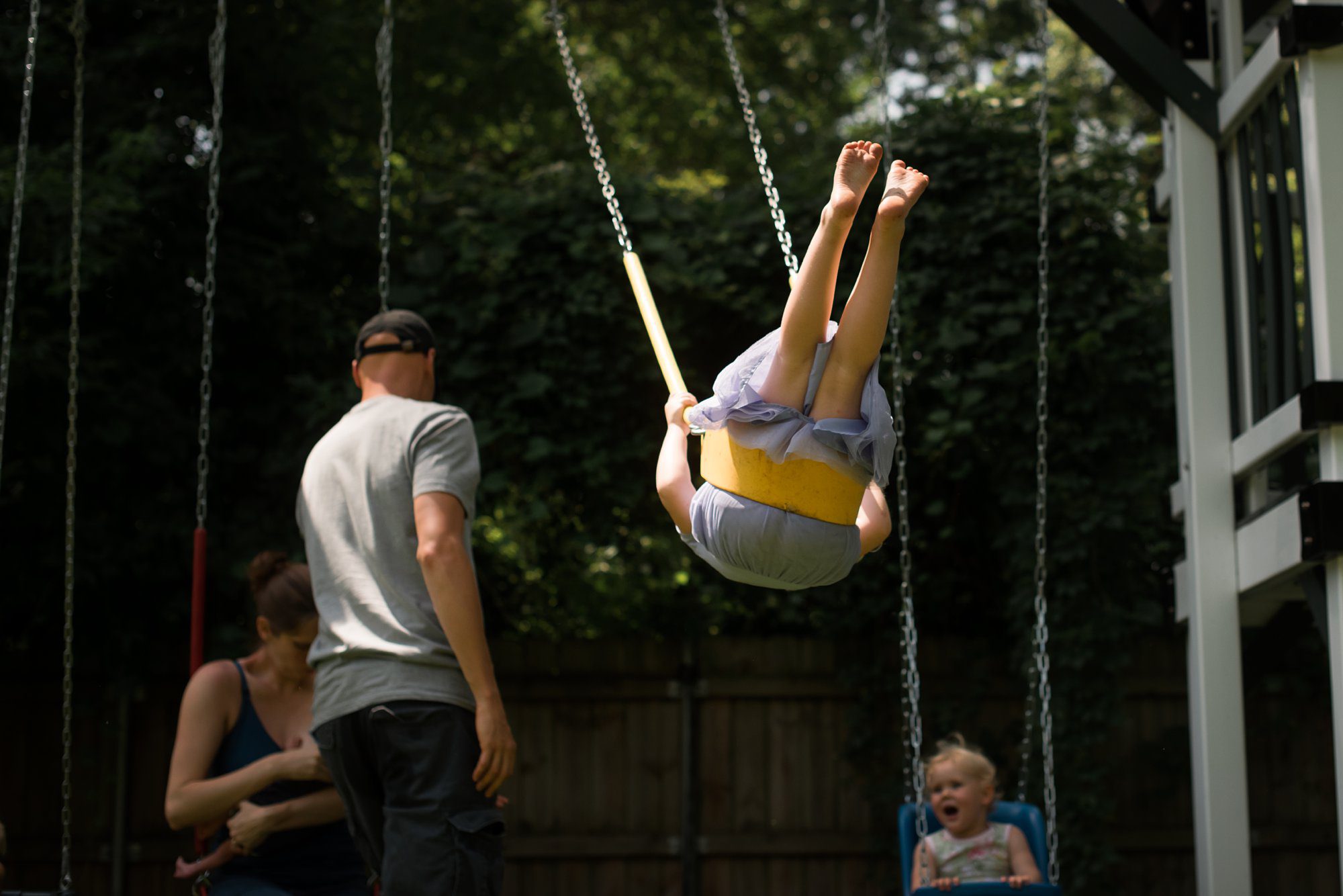 Newborn Family Photographer Toledo family on swing set photo by Cynthia Dawson Photography