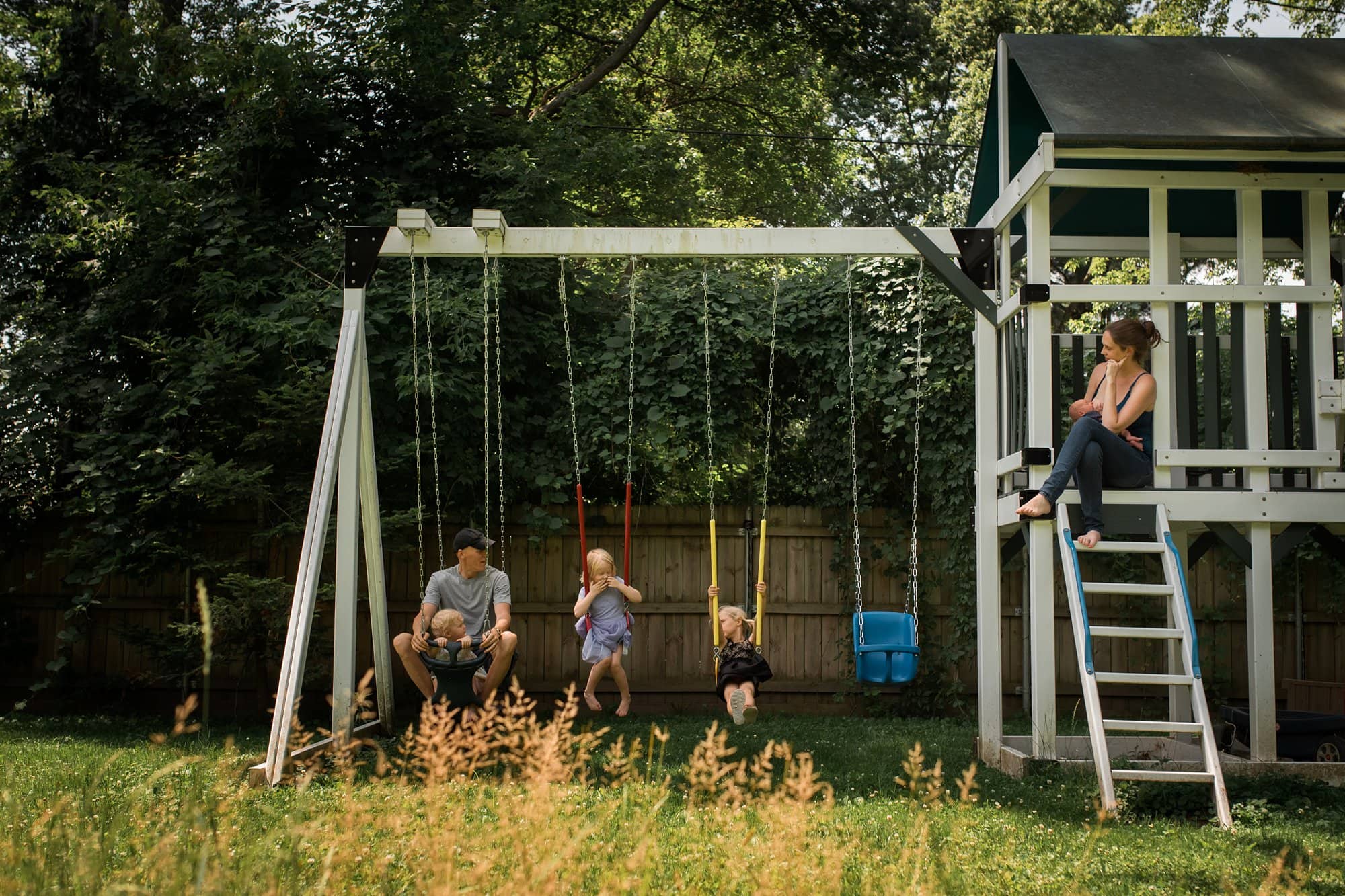 Newborn Family Photographer Toledo family of 6 on swing set photo by Cynthia Dawson Photography