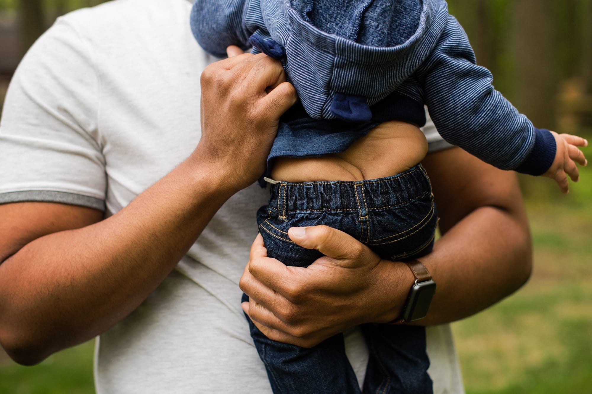 Toledo Baby Photographer close up of dad holding baby photo by Cynthia Dawson Photography