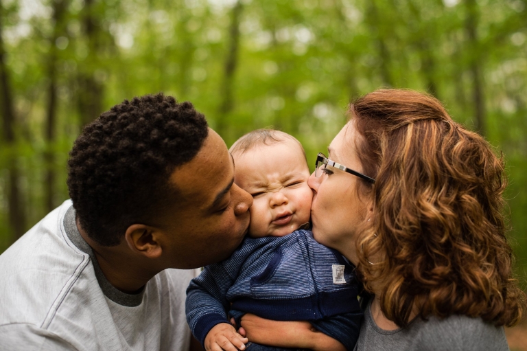 Toledo Family Photographer parents kissing baby photo by Cynthia Dawson Photography