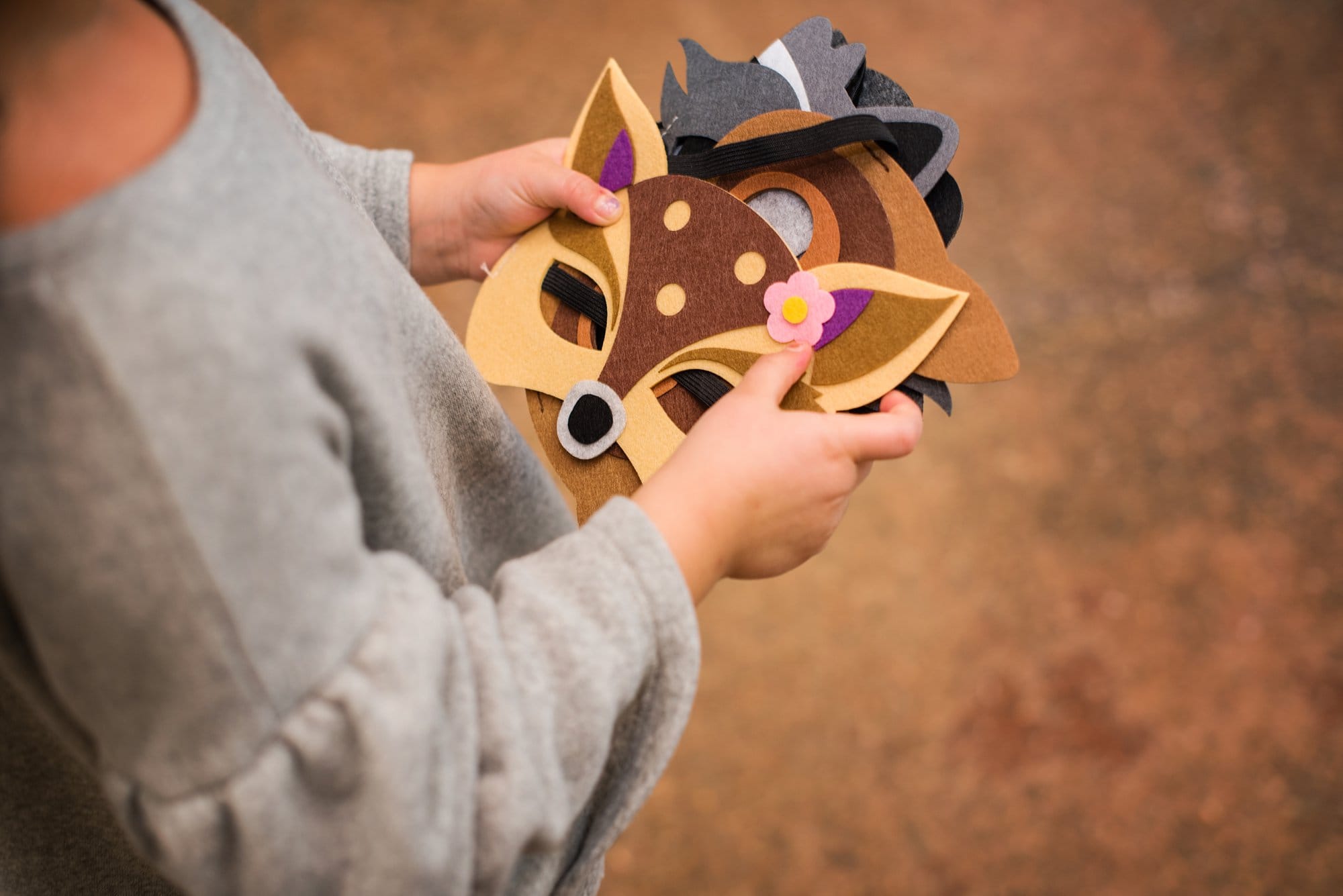 Toledo Event Photography girl holding masks photo by cynthia dawson photography