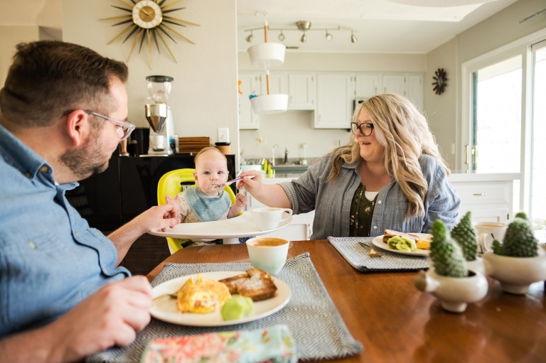 Lifestyle Photographer in Perrysburg Ohio mom and dad feeding baby photo by Cynthia Dawson Photography 