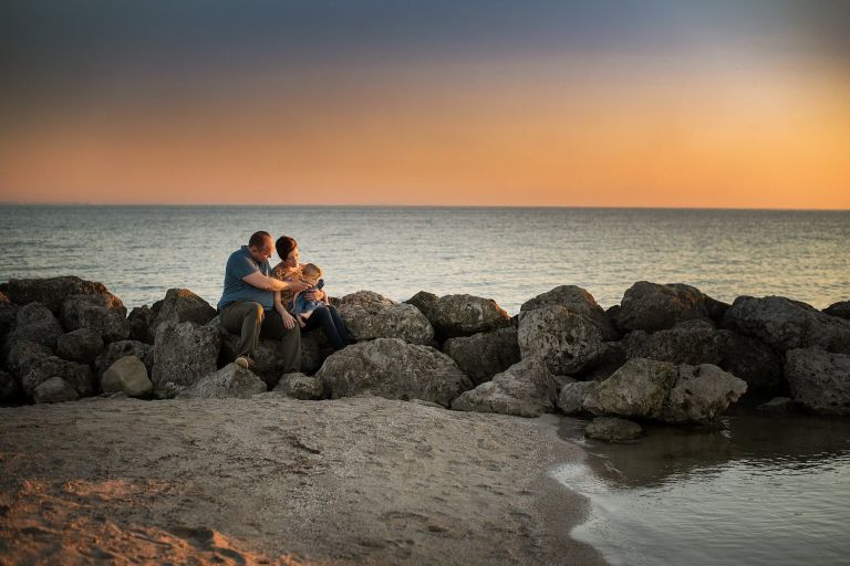 family on rocks at maumee bay state park photo by Cynthia Dawson Photogrpahy 